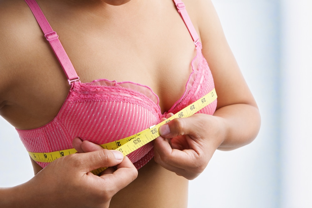 woman measuring her bust size at here own home